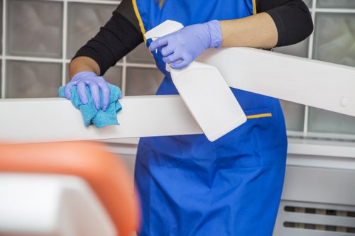 Local technician cleaning a lounge sofa with care in SE23